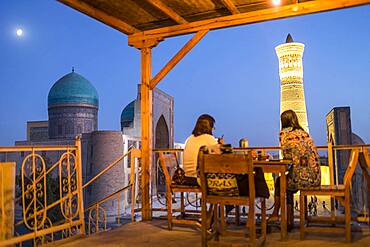 Minor Cafe House. At right Kalon minaret and mosque. At left Mir-i-Arab medressa , Bukhara, Uzbekistan