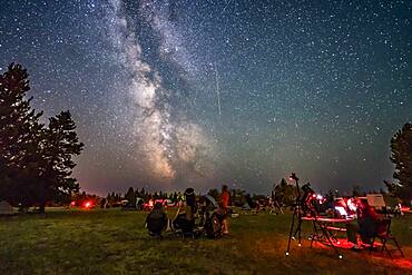 A Perseid meteor streaks down the Milky Way over the Saskatchewan Summer Star Party in the Cypress Hills of southwest Saskatchewan, at Cypress Hills Interprovincial Park, a Dark Sky Preserve. The Milky Way shines to the south. About 350 stargazers attend the SSSP every year.