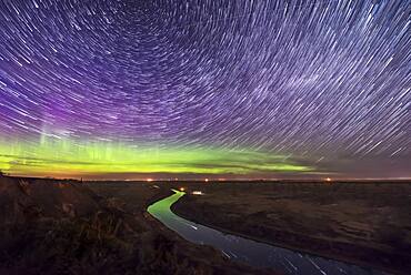 Circumpolar star trails and aurora over the Red Deer River, Alberta from the Orkney Viewpoint north of Drumheller on May 5, 2018.