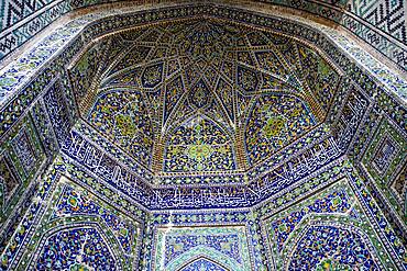 Ornamentation, detail of arc in the courtyard of Sher Dor Medressa, Registan, Samarkand, Uzbekistan