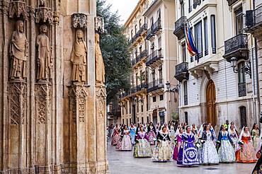 Flower offering parade,People with Floral tributes to `Virgen de los desamparados��, Fallas festival,carrer del Micalet street,Valencia