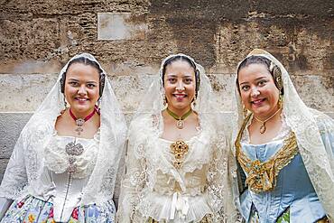 Women in Fallera Costumes during Flower offering parade, tribute to `Virgen de los desamparados��, Fallas festival, Plaza de la Virgen square,Valencia