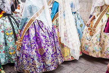 Detail, women in Fallera Costumes during Flower offering parade, tributes to `Virgen de los desamparados��, Fallas festival, Plaza de la Virgen square,Valencia