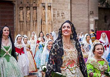 woman looks with emotion the Virgin during flower offering parade,People with Floral tributes to `Virgen de los desamparados��, Fallas festival, Plaza de la Virgen square,Valencia