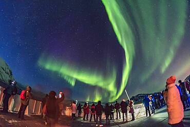 Aurora tourists taking in the sky show on March 14, 2018 from the aft deck of the Hurtigruten ship the m/s Nordnorge on the journey south, from a location north of Tromsø this night.