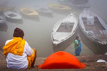 Pilgrims praying, in the ghats of Ganges river, Varanasi, Uttar Pradesh, India.