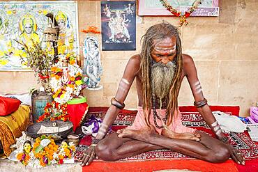 Sadhu meditating, in the ghats of Ganges river, Varanasi, Uttar Pradesh, India.