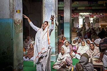 Widows praying in a Bhajan ashram, Vrindavan, Mathura district, India