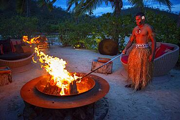 Likuliku Lagoon Resort, Five Star Resort, Malolo Island, Mamanucas, Fiji.  Lighting fire late in the afternoon.