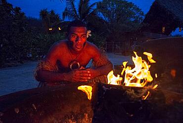 Likuliku Lagoon Resort, Five Star Resort, Malolo Island, Mamanucas, Fiji.  Lighting fire late in the afternoon.