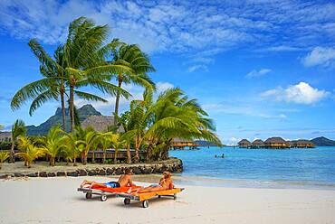 Beach in Le Bora Bora by Pearl Resorts luxury resort in motu Tevairoa island, a little islet in the lagoon of Bora Bora, Society Islands, French Polynesia, South Pacific.