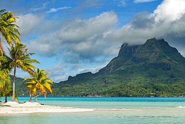 Beach of motu Tevairoa island, a little islet in the lagoon of Bora Bora, Society Islands, French Polynesia, South Pacific.