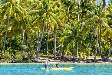 Kayaking in Taha'a island beach, French Polynesia. Motu Mahana palm trees at the beach, Taha'a, Society Islands, French Polynesia, South Pacific.