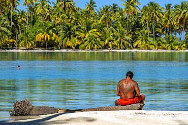 Island of Taha'a, French Polynesia. A local boy plays the ukulele to woo your girl at the Motu Mahana, Taha'a, Society Islands, French Polynesia, South Pacific.