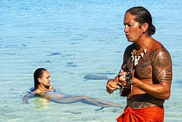 Island of Taha'a, French Polynesia. A local boy plays the ukulele to woo your girl at the Motu Mahana, Taha'a, Society Islands, French Polynesia, South Pacific.