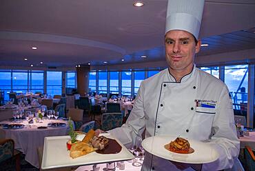 Stefan Berndt, the executive chef of Paul Gauguin show some dishes of the restaurant, 2-star Michelin. Paul Gauguin cruise, Society Islands, Tuamotus Archipelago, French Polynesia, South Pacific.