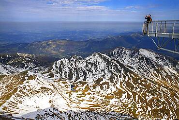 View point of The Observatory Of Pic Du Midi De Bigorre, Hautes Pyrenees, Midi Pyrenees, France. The 12m Ponton dans le ciel, a glass walkway high above the Pyrenees at Pic du Midi de Bigorre, a 2877m mountain in the French Pyrenees, home to an astronomical observatory and visitors centre. The observatory is acccessible from the village of La Mongie by cablecar. Tourists often visit in time for the spectacular sunset across the mountains.