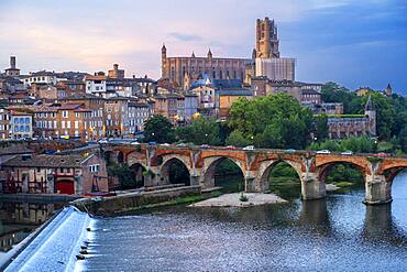 The Tarn River crossing Albi town. Pont Vieux bridge and the Church of Notre Dame du Breuil in Tarn village, Occitanie Midi Pyrenees France.