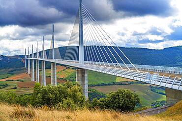 Aerial view Millau viaduct by architect Norman Foster, between Causse du Larzac and Causse de Sauveterre above Tarn, Aveyron, France. Cable-stayed bridge spanning the Tarn River Valley. A75 motorway, built by Michel Virlogeux and Norman Foster, located between Causses de Sauveterre and Causses du Larzac above Tarn River, Natural Regional Park of Grands Causses.