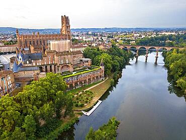 The Tarn River crossing Albi town. Pont Vieux bridge and the Church of Notre Dame du Breuil in Tarn village, Occitanie Midi Pyrenees France.