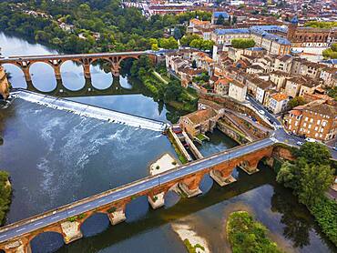 The Tarn River crossing Albi town. Pont Vieux bridge and the Church of Notre Dame du Breuil in Tarn village, Occitanie Midi Pyrenees France.