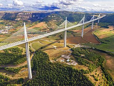 Aerial view Millau viaduct by architect Norman Foster, between Causse du Larzac and Causse de Sauveterre above Tarn, Aveyron, France. Cable-stayed bridge spanning the Tarn River Valley. A75 motorway, built by Michel Virlogeux and Norman Foster, located between Causses de Sauveterre and Causses du Larzac above Tarn River, Natural Regional Park of Grands Causses.