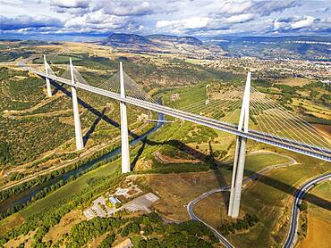 Aerial view Millau viaduct by architect Norman Foster, between Causse du Larzac and Causse de Sauveterre above Tarn, Aveyron, France. Cable-stayed bridge spanning the Tarn River Valley. A75 motorway, built by Michel Virlogeux and Norman Foster, located between Causses de Sauveterre and Causses du Larzac above Tarn River, Natural Regional Park of Grands Causses.