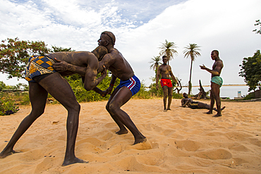 Wrestlers play Senegalese wrestling in Simal