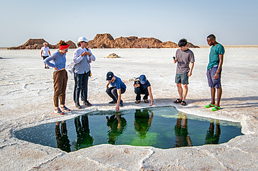 Water of Lake Karum, visible through a hole in the salt flat, Danakil Depression, Ethiopia.