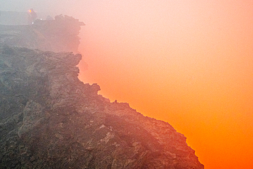 Apocalyptic look scenes as glowing red smoke pours out of Erta Ale Volcano, a continuously active basaltic shield volcano and lava lake in the Afar Region of Ethiopia