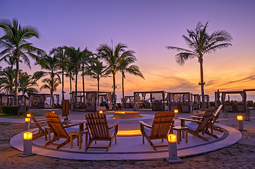 Sunset around the beachside fire pit at Marival Resort's Mozzamare Beach Club in Nuevo Vallarta, Riviera Nayarit, Mexico.