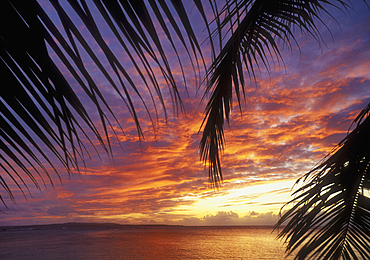 Sunset from the Pacific Islands Club resort with Tinian Island in the distance; Saipan, Northern Marianas Islands, Micronesia..