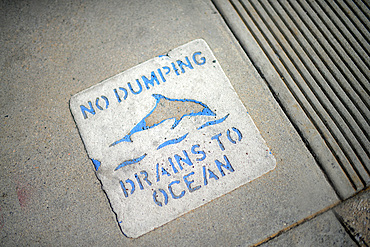 No Dumping, Drains to Ocean sign on sidewalk, Los Angeles, California.