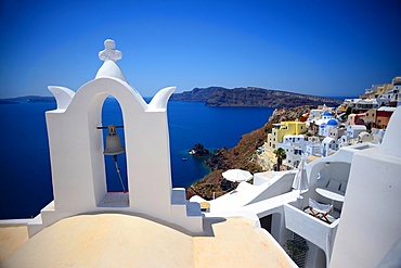 Church bell and hillside buildings in Oia, Santorini, Greek Islands, Greece