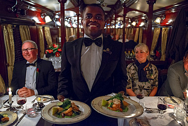 Passengers having dinner in the restaurant car of the The Rovos Rail luxury train travelling between Cape Town and Pretoria in South Africa Pride of Africa beautifully rebuilt Classic train that form part of the luxurious and privately owned Rovos Rail fleet