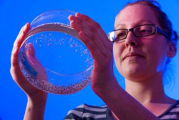 Woman conducting research in an aquaculture lab at Delaware State University