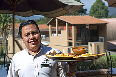 Waiter with the breakfast in Filadelfia coffee estate, R. Dalton Coffee Company, Antigua, Guatemala.