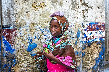 Funy girl in the narrow strees of the city town of Lamu in Kenya