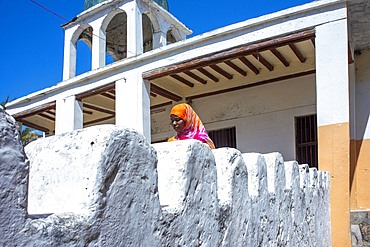 Swahili woman and white house in the city town of Lamu in Kenya