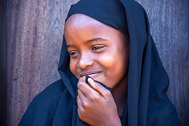 Funy swahili girl portrait in the strees of the city town of Lamu in Kenya