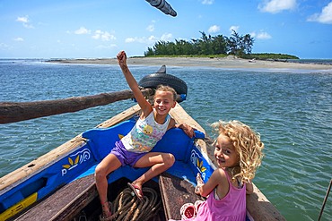 Tourists european girls inside a dhow sailing boat in Lamu archipelago, Kenya.