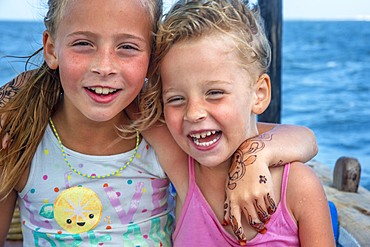 Tourists european girls inside a dhow sailing boat in Lamu archipelago, Kenya.