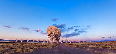 The Very Large Array (VLA) radio telescope in New Mexico, at sunset, March 17, 2013, with the Earth shadow rising at right and the pink Belt of Venus along the eastern horizon. This is a 2-section panorama, hand-held, with the 14mm lens and Canon 60Da camera.