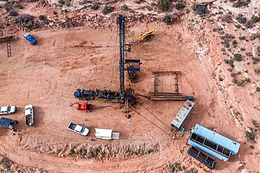 A pulling unit or workover rig providing maintenance on an oil well in the canyon country of Utah.