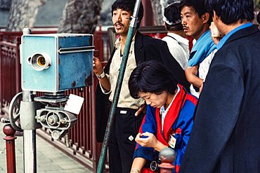 A Chinese photographer making souvenir portraits for tourists at the Summer Palace in Beijing, China.