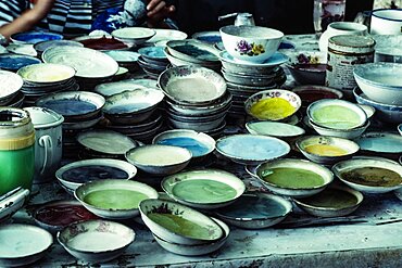 Bowls of colored frit or powdered glass enamel for making cloisonne in a workshop in Beijing, China.