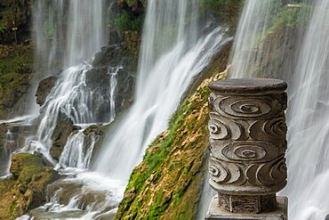 A sculpted bronze finial on the guard rail of the path behind the Wangcun Waterfall in Furong, Hunan, China.