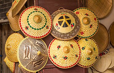 Traditional woven bamboo conical hats for sale on the street in the ancient town of Furong, China.