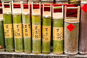 Bamboo containers of rice wine for sale on the street in the ancient town of Furong, China.