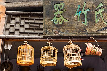 Split bamboo birdcages on display for sale on the street in the ancient town of Furong, Hunana, China.